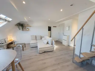 a living room with a couch and a table at Cosy duplex in Brussels in Brussels