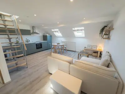 a living room with a couch and a table at Cosy duplex in Brussels in Brussels