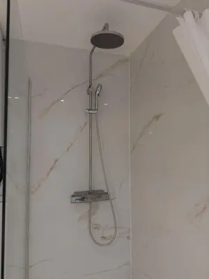 a shower with a shower head in a bathroom at Cosy duplex in Brussels in Brussels
