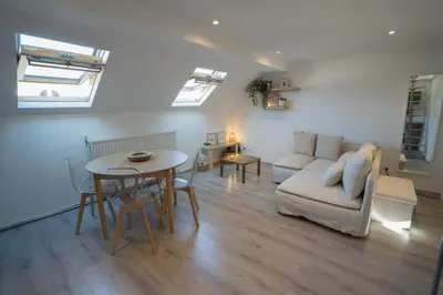 a living room with a couch and a table at Cosy duplex in Brussels in Brussels