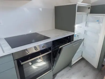 a kitchen with a stove and an open refrigerator at Cosy duplex in Brussels in Brussels