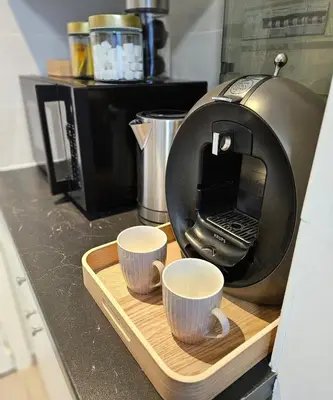 a coffee maker with two coffee cups on a cutting board at Studio Brussels centre in Brussels