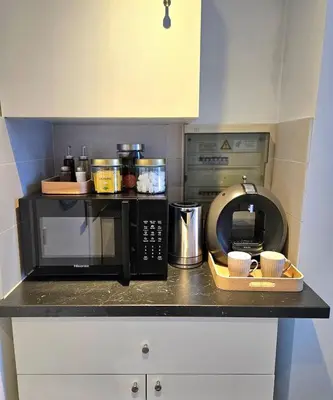 a kitchen counter with a microwave and a coffee maker at Studio Brussels centre in Brussels