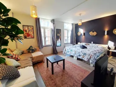 a living room with a bed and a couch at Dodo Guest House in Brussels