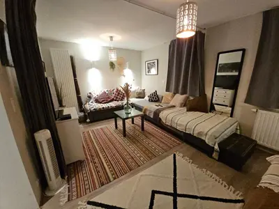 a living room with a couch and a table at Dodo Guest House in Brussels