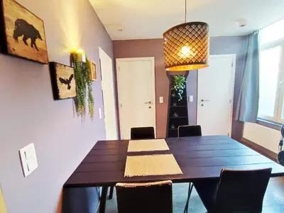 a dining room with a wooden table and chairs at Dodo Guest House in Brussels