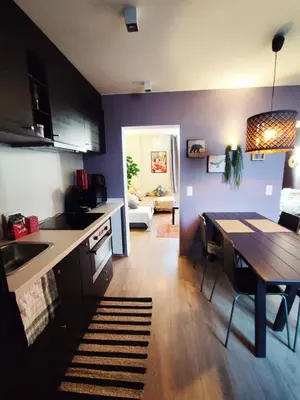 a kitchen with a table and a dining room at Dodo Guest House in Brussels