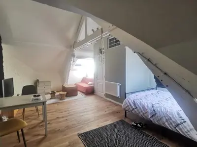 a room with a staircase with a bed and a desk at Dodo Guest House in Brussels