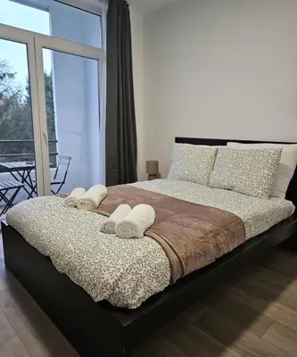 a bedroom with a large bed with towels on it at Brussels apartment with terrace 1 in Brussels