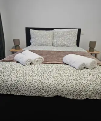 a bed with two towels and two pillows on it at Brussels apartment with terrace 1 in Brussels