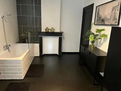 a bathroom with a tub and a shower and a sink at B&B Het Routehuis in Hulshout