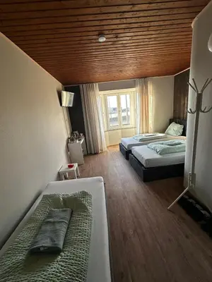 a bedroom with two beds and a wooden ceiling at Antwerp SportPlaza in Antwerp