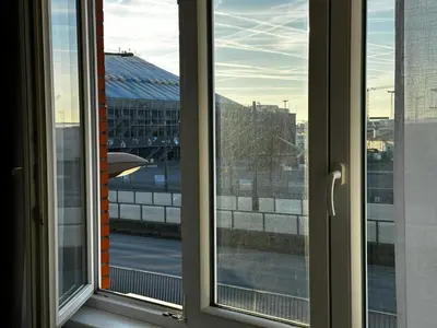 a window with a view of a city at Antwerp SportPlaza in Antwerp