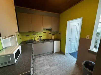 a kitchen with a microwave on a counter and a door at Antwerp SportPlaza in Antwerp