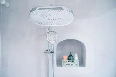 a bathroom with a shower with a light hanging from the ceiling at Appartement 2 chambres avec rooftop suspendu au Cimetière d'Ixelles in Brussels