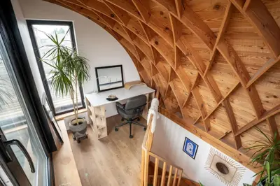 an attic office with a wooden ceiling and a desk at Appartement 2 chambres avec rooftop suspendu au Cimetière d'Ixelles in Brussels