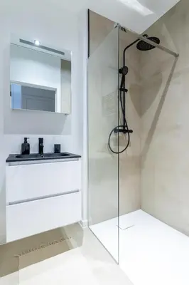 a bathroom with a shower and a sink at Sleek City Stays - Urban Elegance in the Heart of Ghent in Ghent