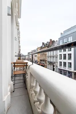 a balcony with a view of a city at Sleek City Stays - Urban Elegance in the Heart of Ghent in Ghent