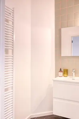 a white bathroom with a sink and a mirror at 2-BR Getaway with MAS view in Antwerp