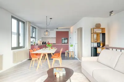 a living room with a couch and a table at 2-BR Getaway with MAS view in Antwerp