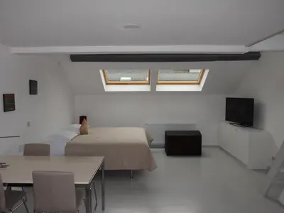a bedroom with a bed and a table and a television at Aparthotel Midi Residence in Brussels