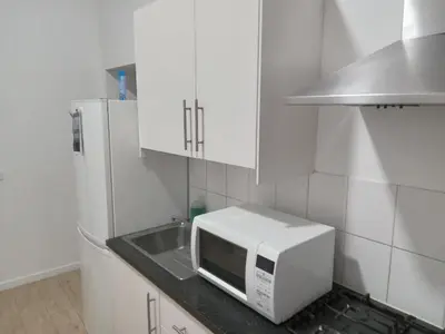 a kitchen with a microwave and a sink at Lux chamber in Brussels