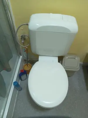 a white toilet in a bathroom with a shower at Lux chamber in Brussels