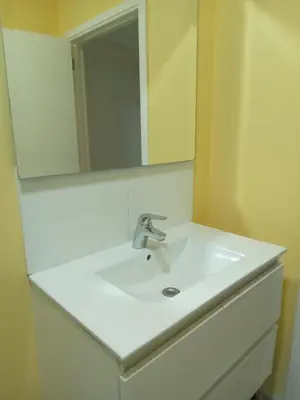 a bathroom with a white sink and a mirror at Lux chamber in Brussels