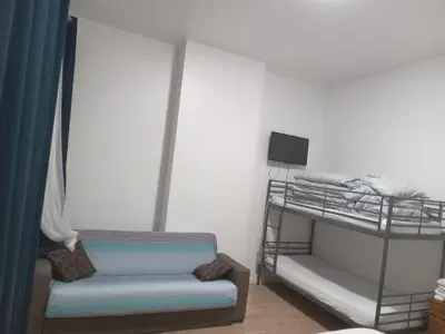 a room with a bunk bed and a couch at Lux chamber in Brussels