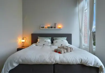 a bedroom with a white bed with teddy bears on it at 2BR apartment at new Zuidpark in Antwerp