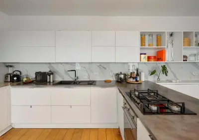 a white kitchen with a stove and white cabinets at 2BR apartment at new Zuidpark in Antwerp