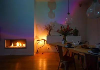 a living room with a table and a fireplace at 2BR apartment at new Zuidpark in Antwerp