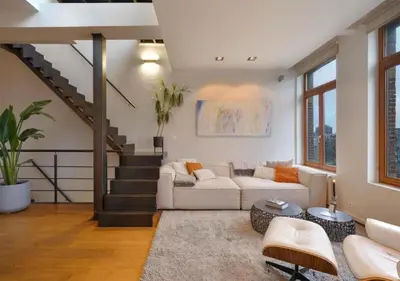 a living room with a couch and a staircase at 2BR apartment at new Zuidpark in Antwerp