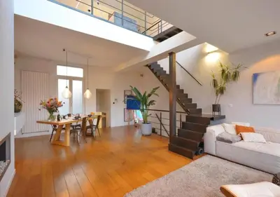 a living room with a white couch and a table at 2BR apartment at new Zuidpark in Antwerp