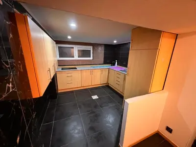 a small kitchen with wooden cabinets and a refrigerator at Bruxelles centre-ville in Brussels