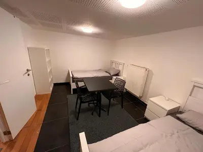 a room with a table and chairs and a bed at Bruxelles centre-ville in Brussels