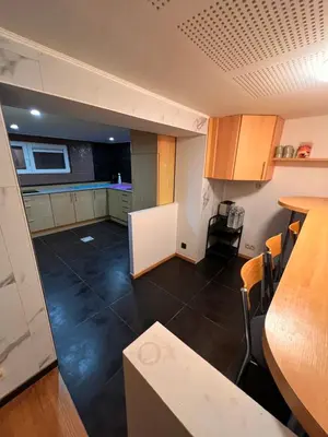 a kitchen and a living room with a table at Bruxelles centre-ville in Brussels