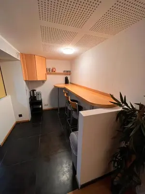 a kitchen with a table and chairs in a room at Bruxelles centre-ville in Brussels