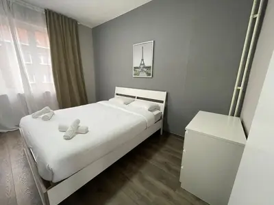 a bedroom with a bed with two teddy bears on it at Cozy City Escape in Brussels