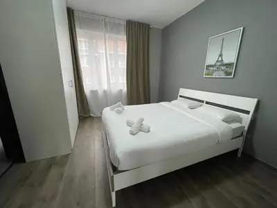 a bedroom with a bed with two teddy bears on it at Cozy City Escape in Brussels