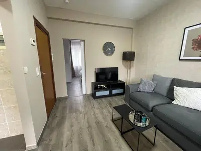 a living room with a couch and a table at Cozy City Escape in Brussels