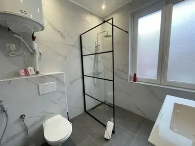 a bathroom with a shower and a toilet and a sink at Cozy City Escape in Brussels
