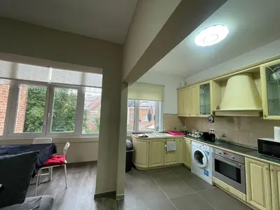 a kitchen with yellow cabinets and a stove top oven at Cozy City Escape in Brussels