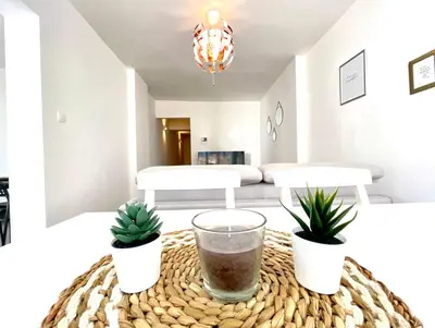 a living room with two potted plants on a table at COSY Duplex - EU DISTRICT in Brussels