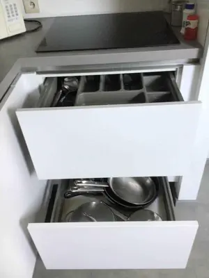 an open drawer in a kitchen with pots and pans at Cosy attic apartment, terrace, 1 bedroom south, 1 double bed for 2, plus single bed if 3 guests in Opdorp