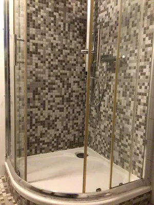a shower with a glass door in a bathroom at Cosy attic apartment, terrace, 1 bedroom south, 1 double bed for 2, plus single bed if 3 guests in Opdorp