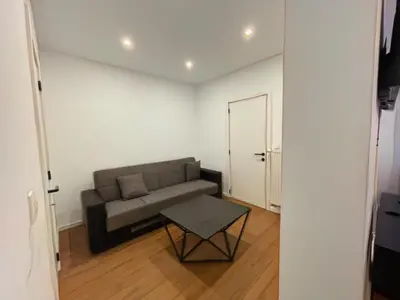 a living room with a couch and a table at La Perla Appartements in Brussels