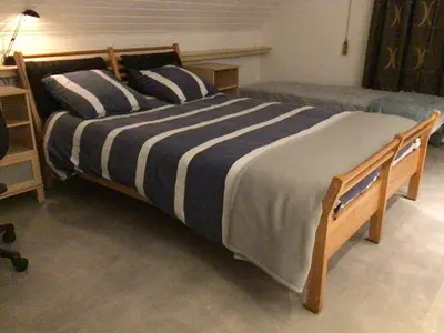 a bed with two pillows on it in a bedroom at Entire first floor, kitchen, bathroom, roofterrace, 1 bedroom if max 3 guests or 2 bedrooms if max 5 guests in Buggenhout