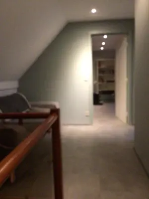 an attic room with a staircase and a hallway at Entire first floor, kitchen, bathroom, roofterrace, 1 bedroom if max 3 guests or 2 bedrooms if max 5 guests in Buggenhout