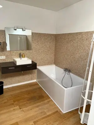 a bathroom with a white tub and a sink at Temse city center in Temse